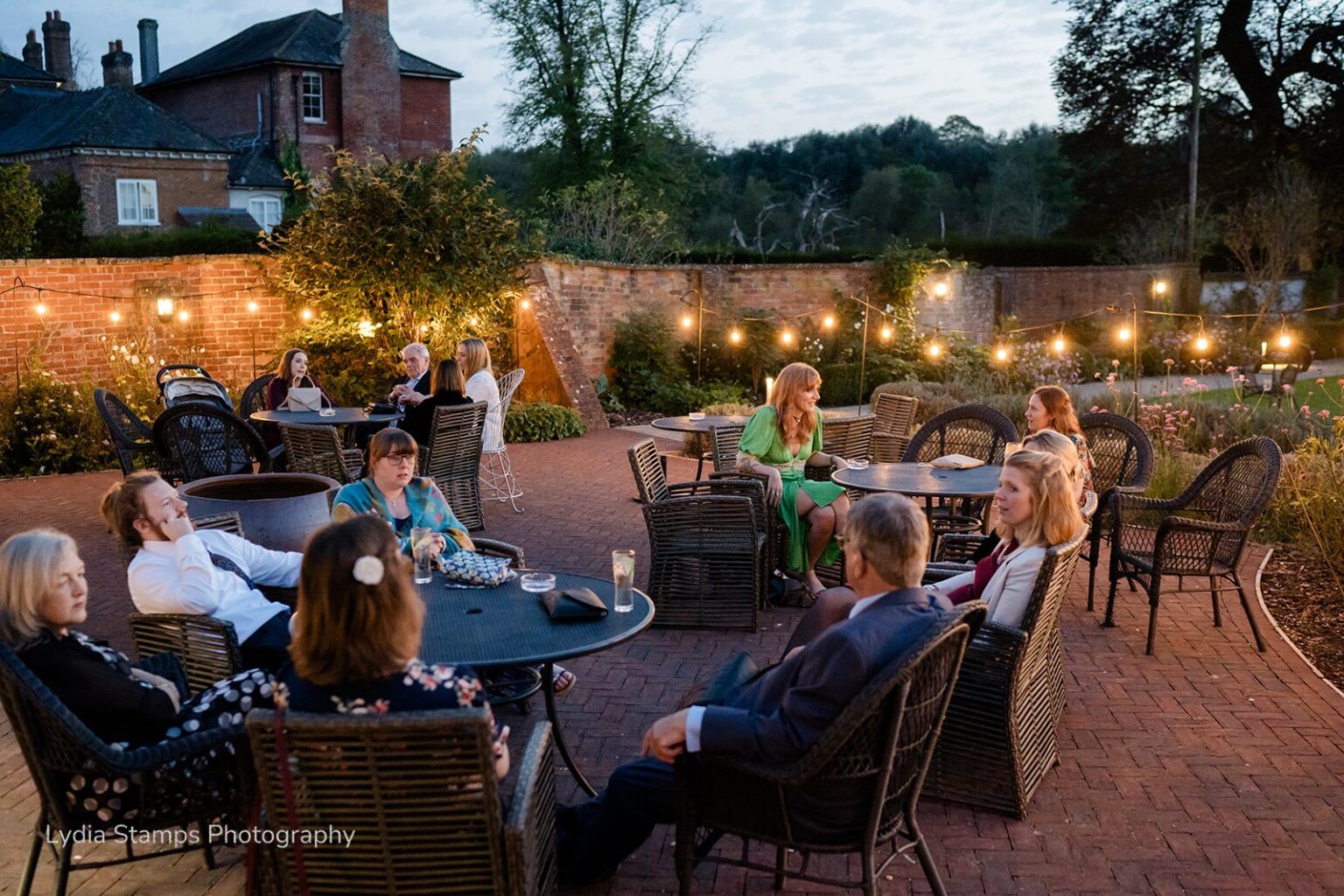 Wedding guest gathering outside at dusk.